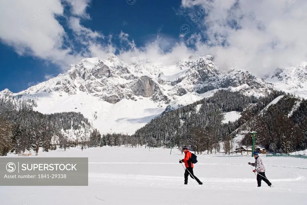 Tourists skiing on snow covered landscape, Dachstein Mountains, Ramsau am Dachstein, Liezen, Styria, Austria