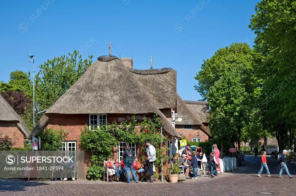 Group of people in front of a frisian house, Nieblum, Foehr, Schleswig_Holstein, Germany