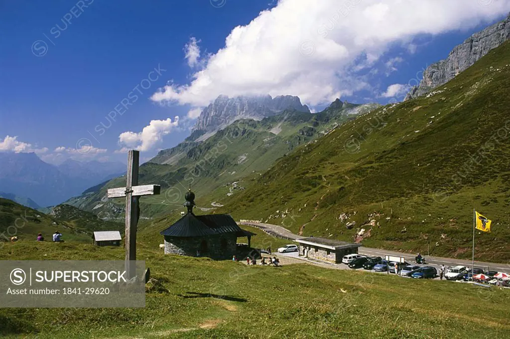 Crucifix on landscape near country road, Switzerland