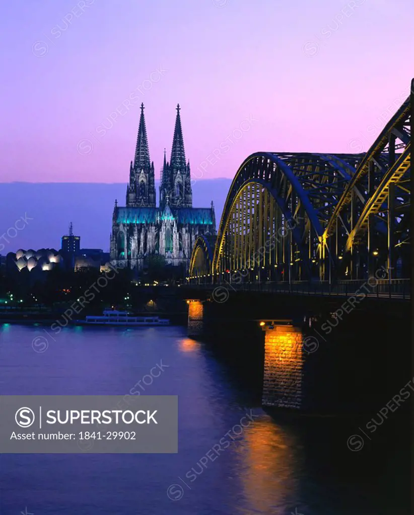 Railroad Bridge across river at dusk, Hohenzollern Bridge, Cologne, Germany