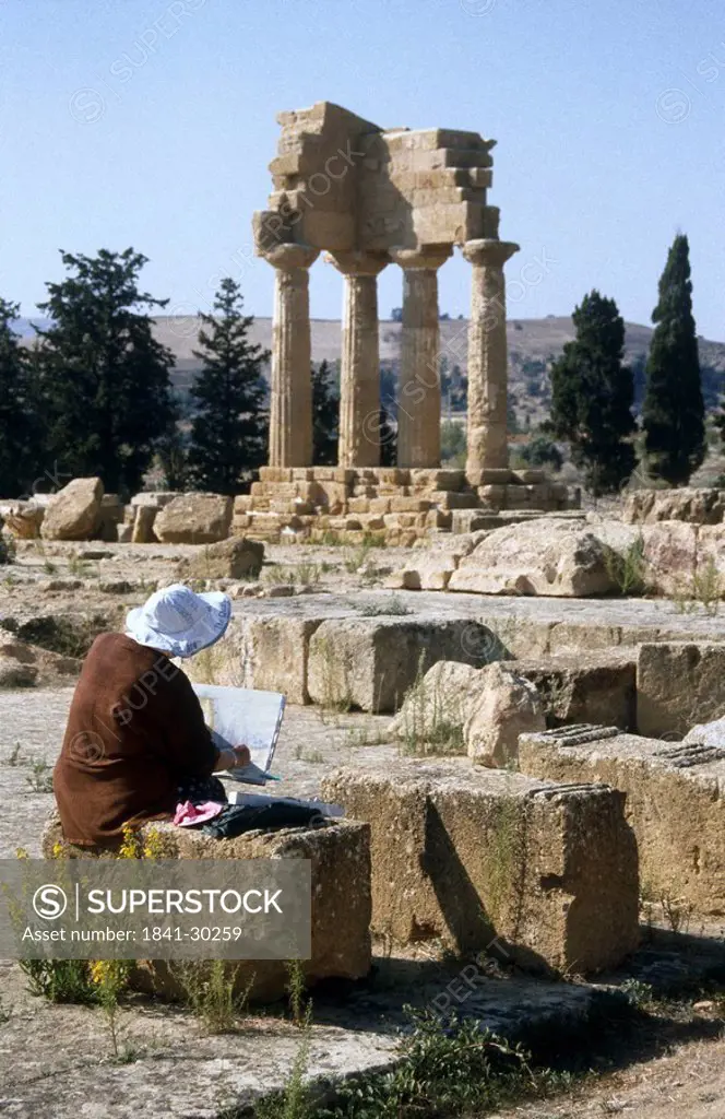 Tourist at old ruins of temple, Agrigento, Sicily, Italy