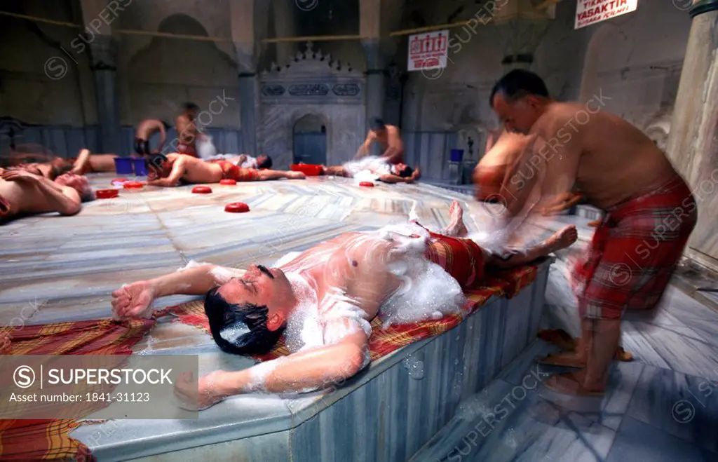 Men laying and getting soaped in Turkish Bath, Istanbul, Turkey