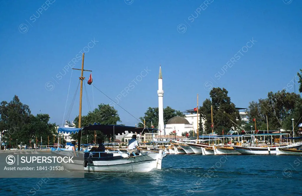 Two people on boat neat harbor, Fethiye, Mugla, Turkey