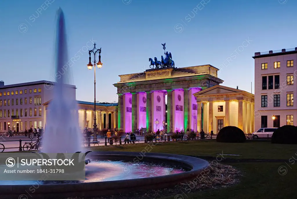 Tourists in front of gate at dusk, Brandenburg Gate, Berlin, Germany