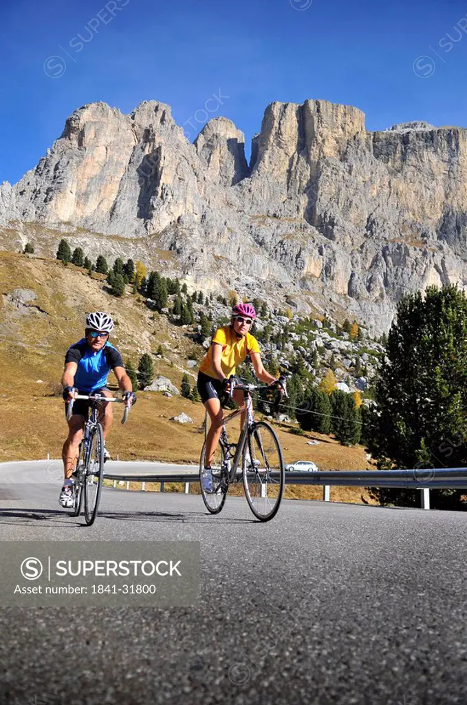 Two mountain bikers cycling together, Dolomites, Italy
