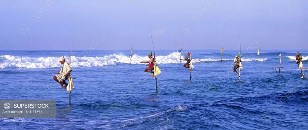 Fisherman fishing on beach