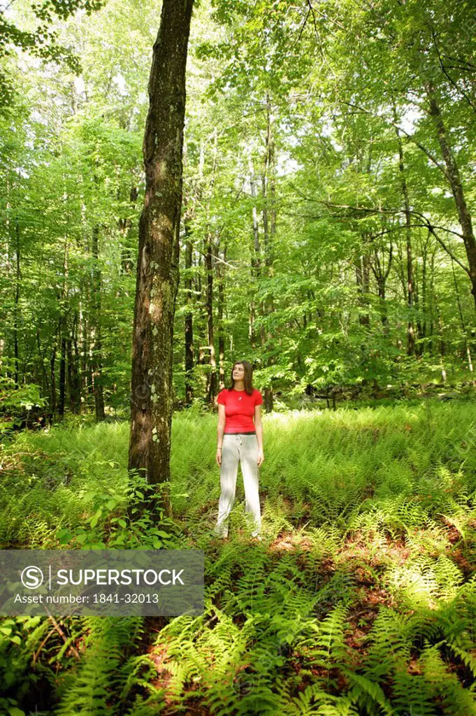 Woman standing in a forest