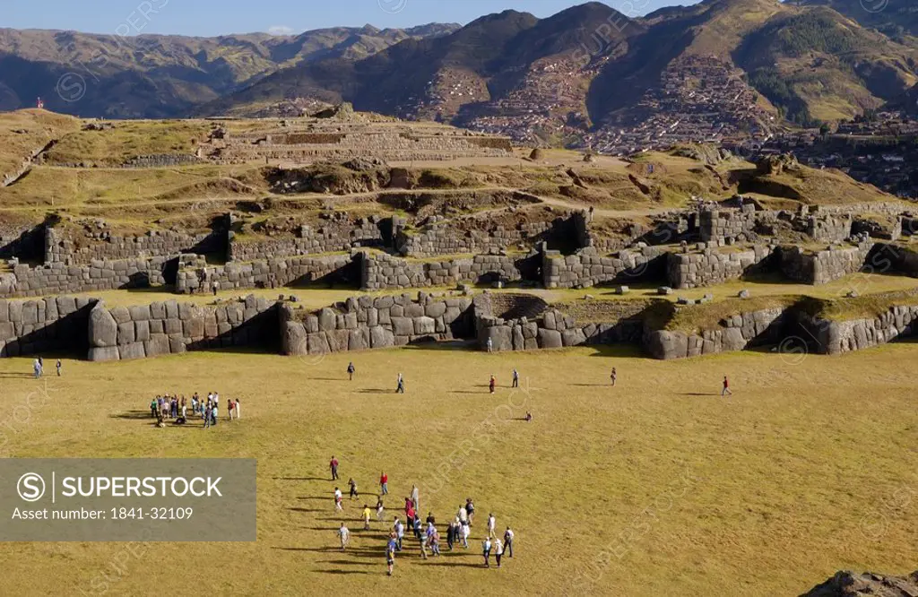 Tourists watching old ruins of fortress, Sacsayhuaman, Cuzco, Cusco Region, Peru