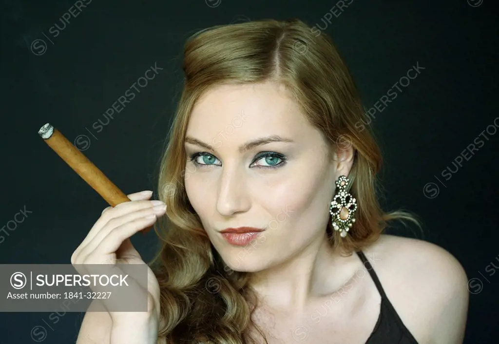 Young woman holding cigar