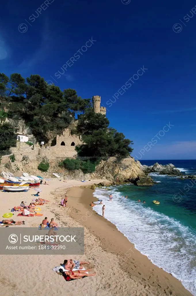 Tourists on beach, Lloret de Mar, Girona Province, Catalonia, Spain