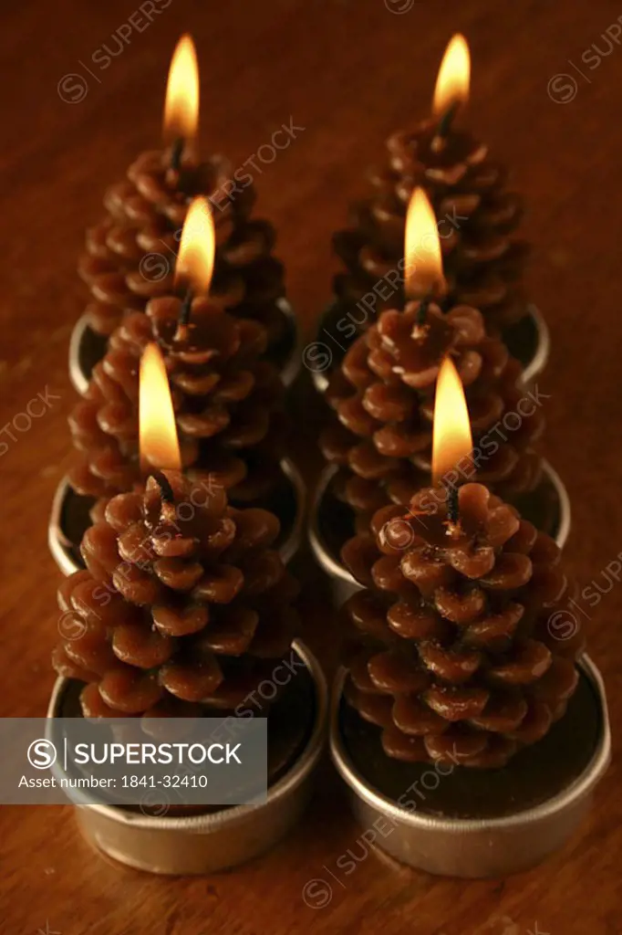High angle view of pine cones shape lit candles