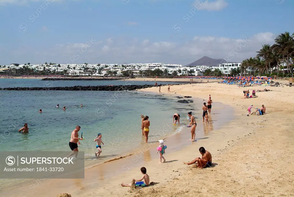 Tourists on beach, Costa Teguise, Playa des Cucharas, Lanzarote, Canary Islands, Spain