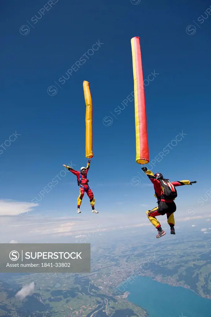 two people doing parachute jumping, full shot