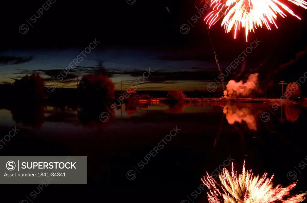 Reflection of fireworks and clouds in water