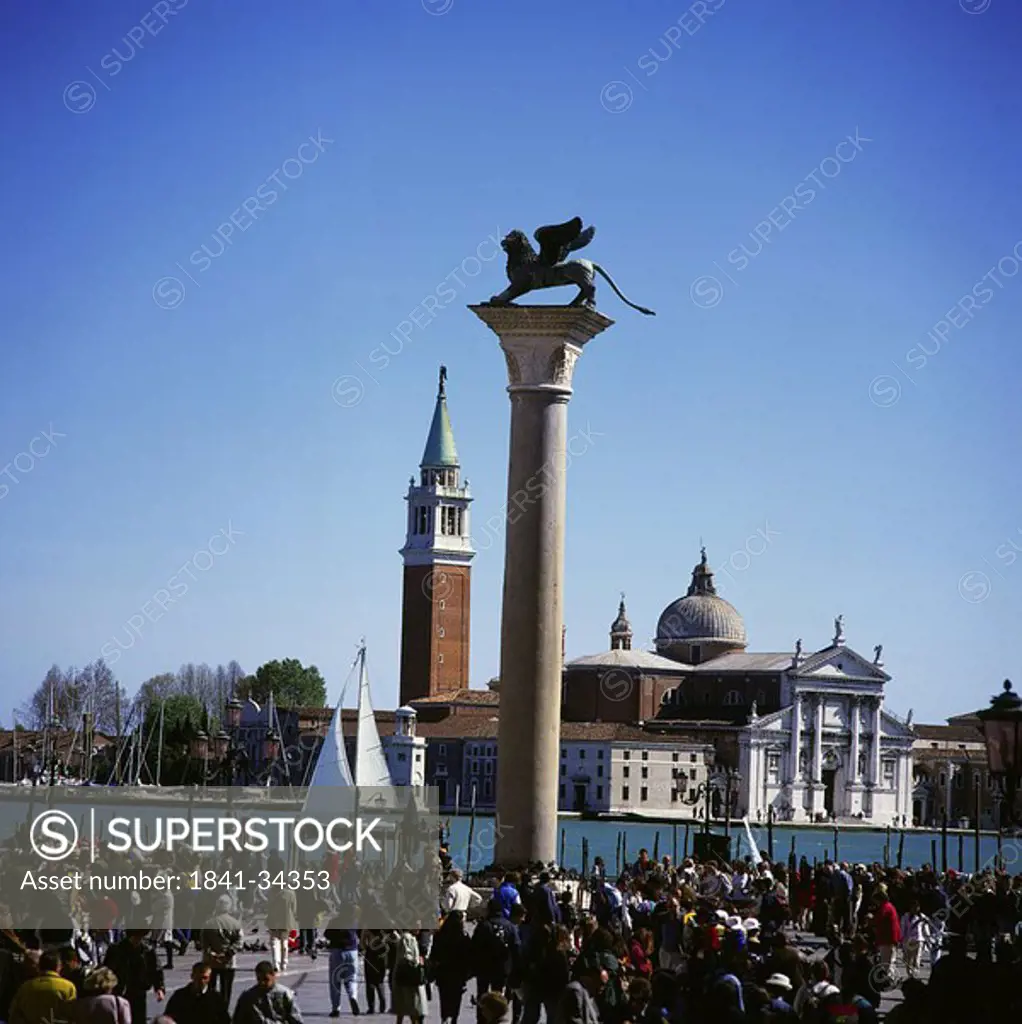 Tourists walking near column, Column Of San Marco, St. Marks Square, San Giogio Maggiore, Venice, Italy