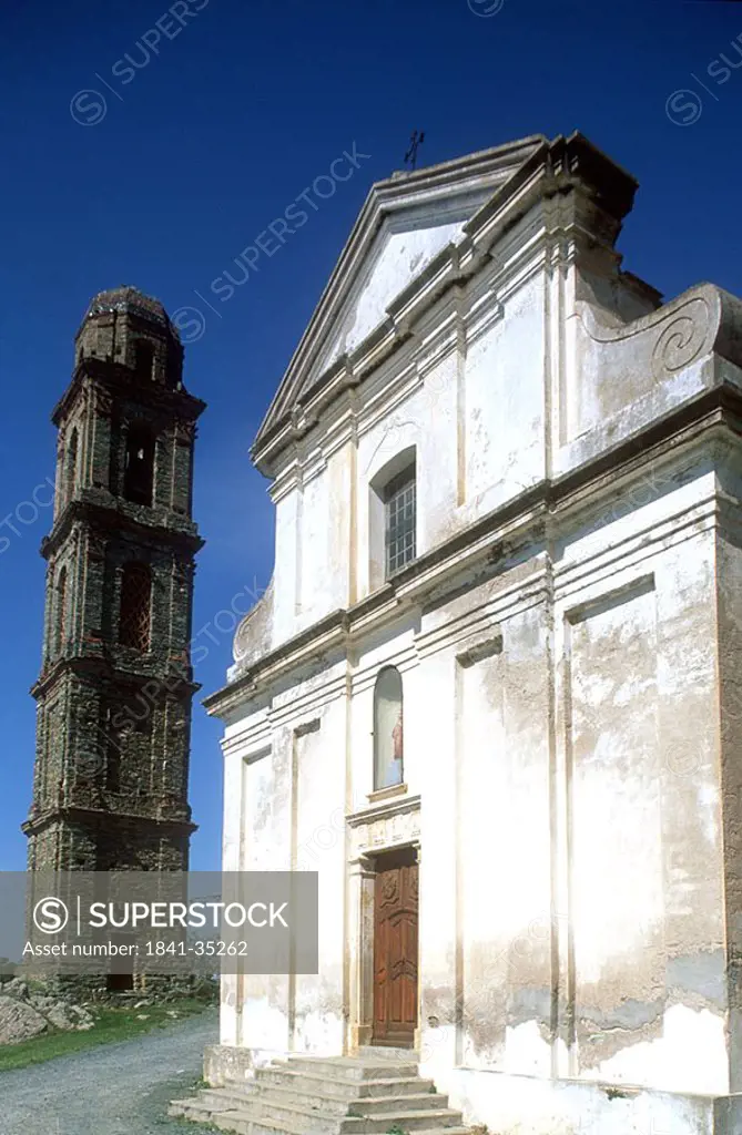 Tower besides church against blue sky, Church Of Pieve, Corsica, France