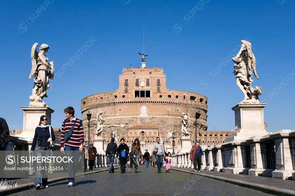 Tourists walking on bridge in front of cathedral, Castle Sant´Angelo, Ponte Sant´Angelo, Rome, Italy