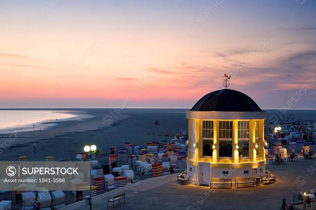 Pavilion and hooded beach chairs on beach at dusk, Borkum, Lower Saxony, Germany