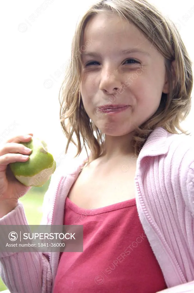 Portrait of girl eating apple