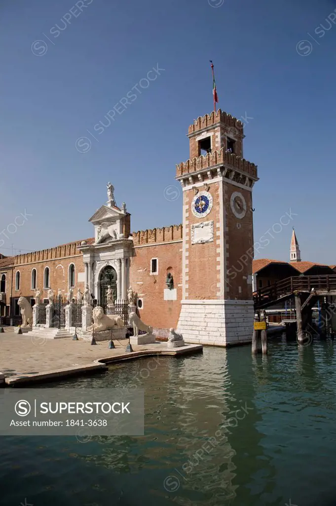 Clock tower and museum at canal side, Museo Storico Navale, Arsenale, Veneto, Venice, Italy