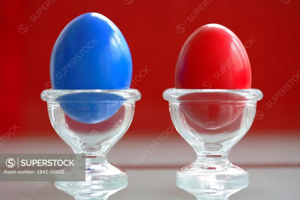 Close_up of two Easter eggs in egg holders