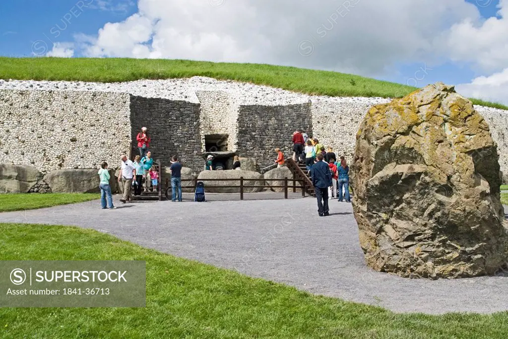 Tourists in front of building, Newgrange, Knowth, Boyne Valley, County Meath, Leinster, Ireland