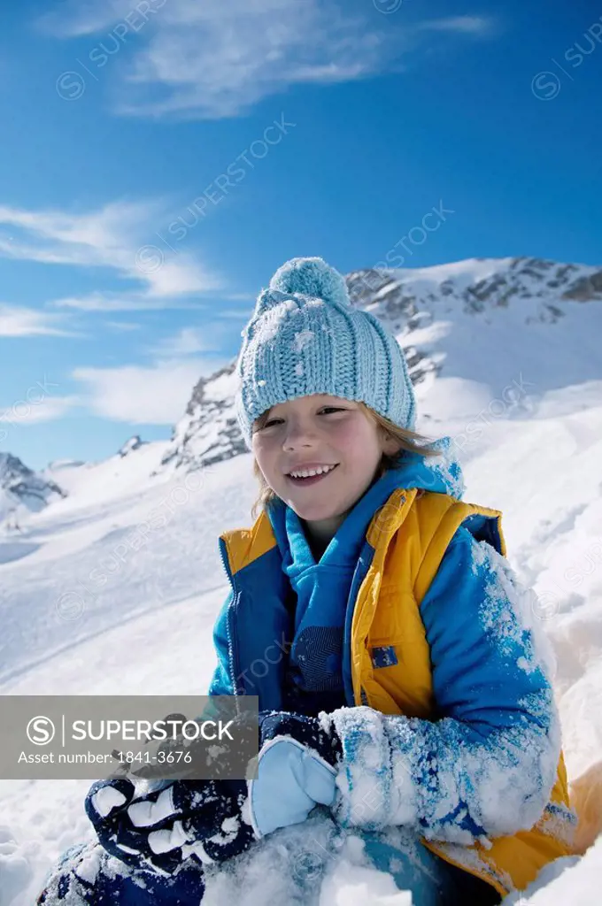 Portrait of boy smiling on snowcovered landscape