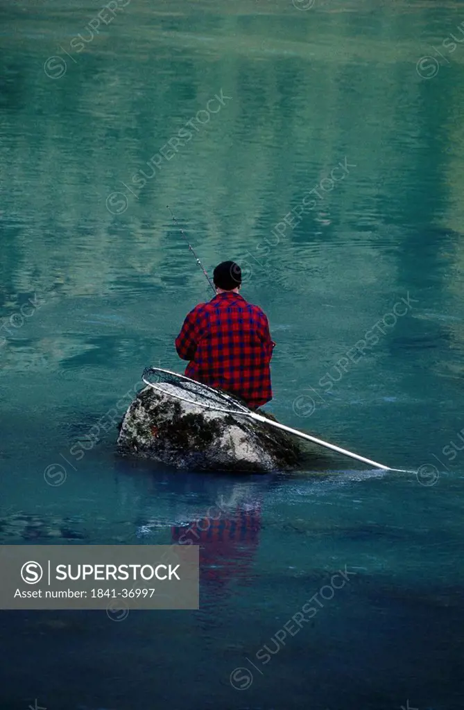 Rear view of fisherman fishing in river, Chilkoot River, Haines, Alaska, USA