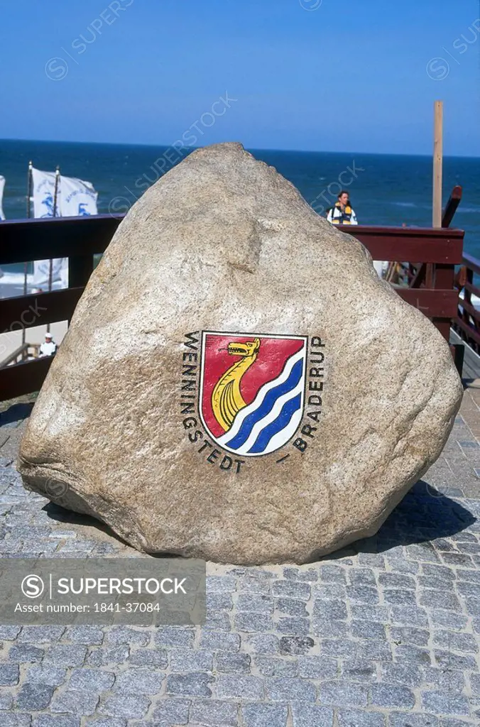 Coat of arms on rock at coast, Wenningstedt_Braderup, Sylt, Nordfriesland, Schleswig_Holstein, Germany