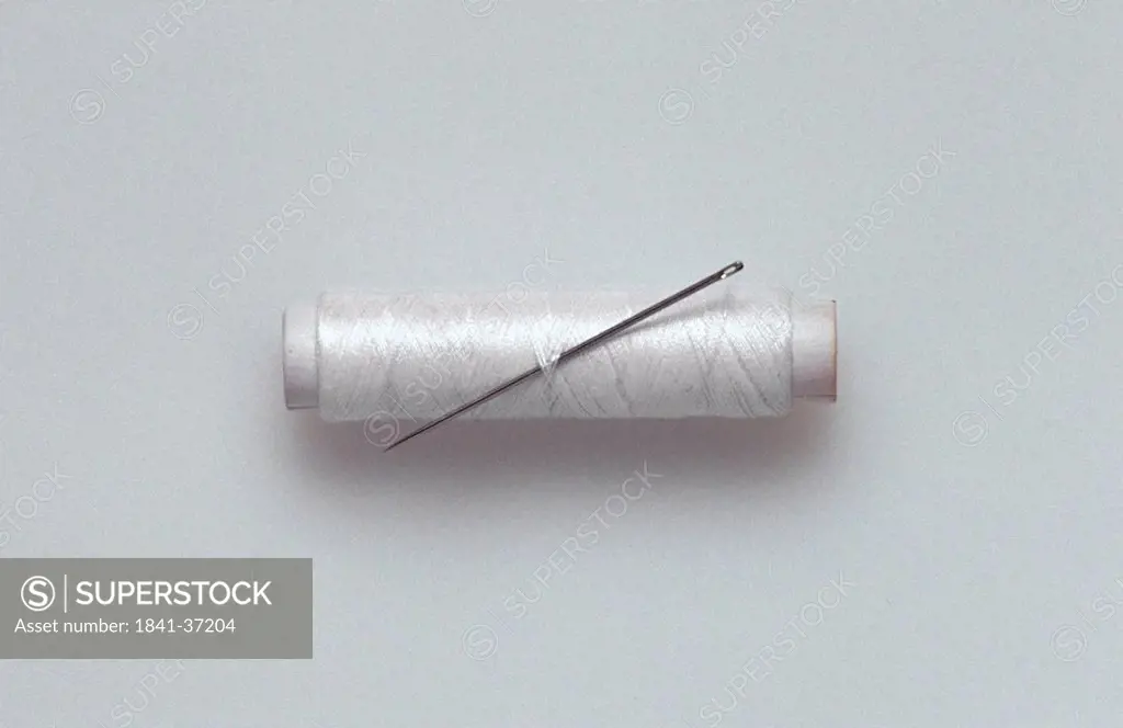 Close_up of needle and spool of thread