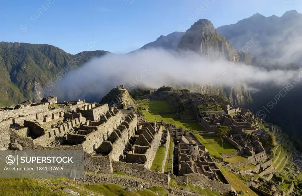 Clouds over old ruins on mountain, Inca Ruins, Machu Picchu, Cusco Region, Peru