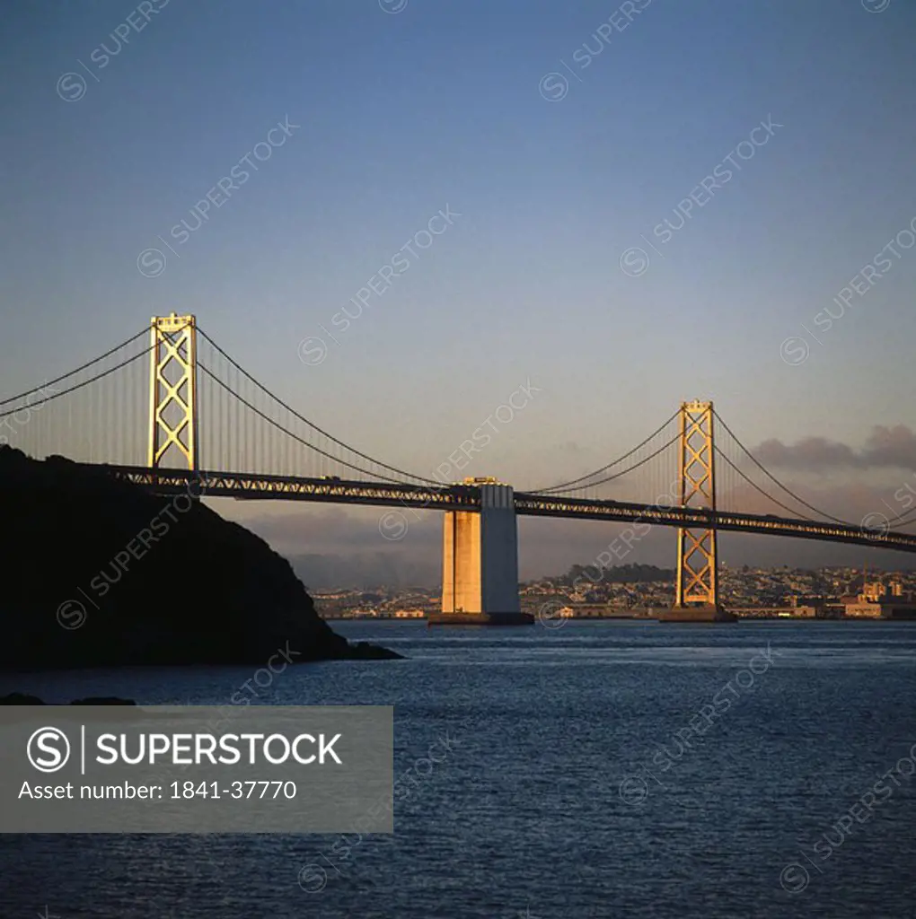 Bridge across river at dusk, Bay Bridge, San Francisco, California, USA