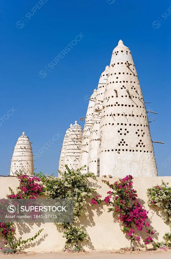 Low angle view of pigeon houses against blue sky, Egypt
