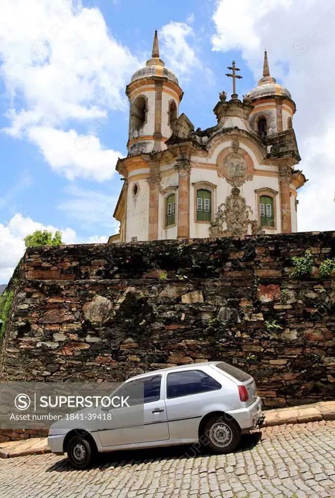 Car in front of a wall, Sao Francisco church in the background, Ouro Preto, Minas Gerais, Brazil