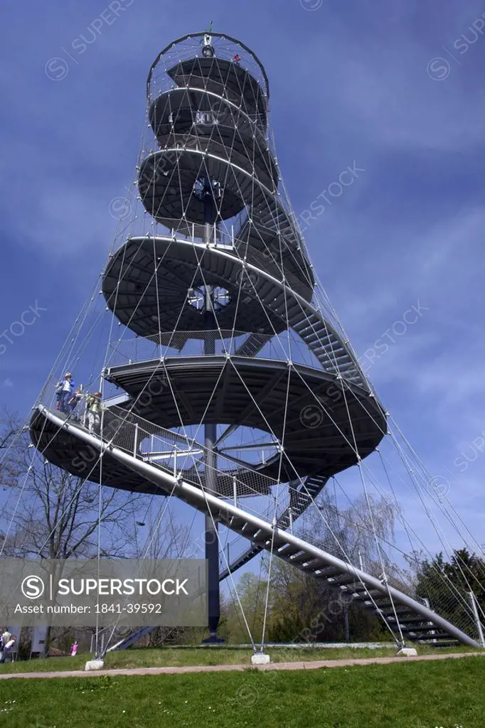 Low angle view of two people on steel structure in park, Killesbergpark, Stuttgart, Germany