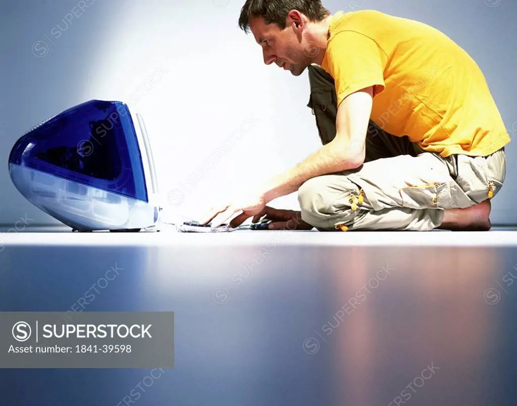 Side profile of man working on computer