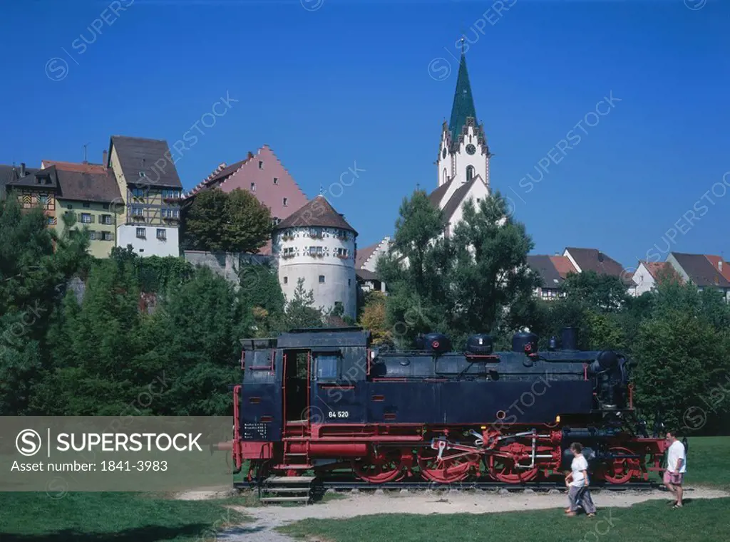 Two people near steam locomotive engine in garden, Baden_Wurttemberg, Germany
