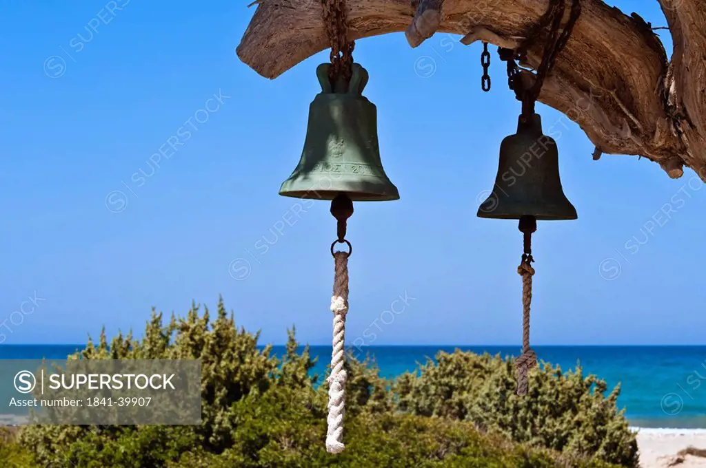 Two bells hanging on a limb of a tree, Cos, Greece