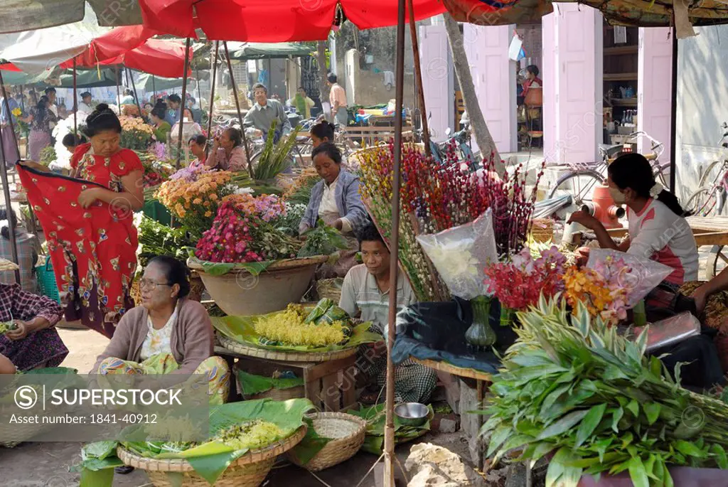 Vendors at market stall in town, Zegyo Market, Mandalay, Myanmar