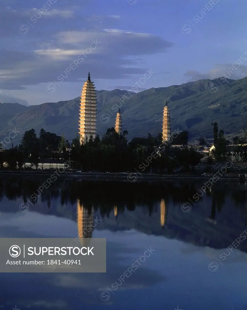 Pagodas reflected in river at dusk, China