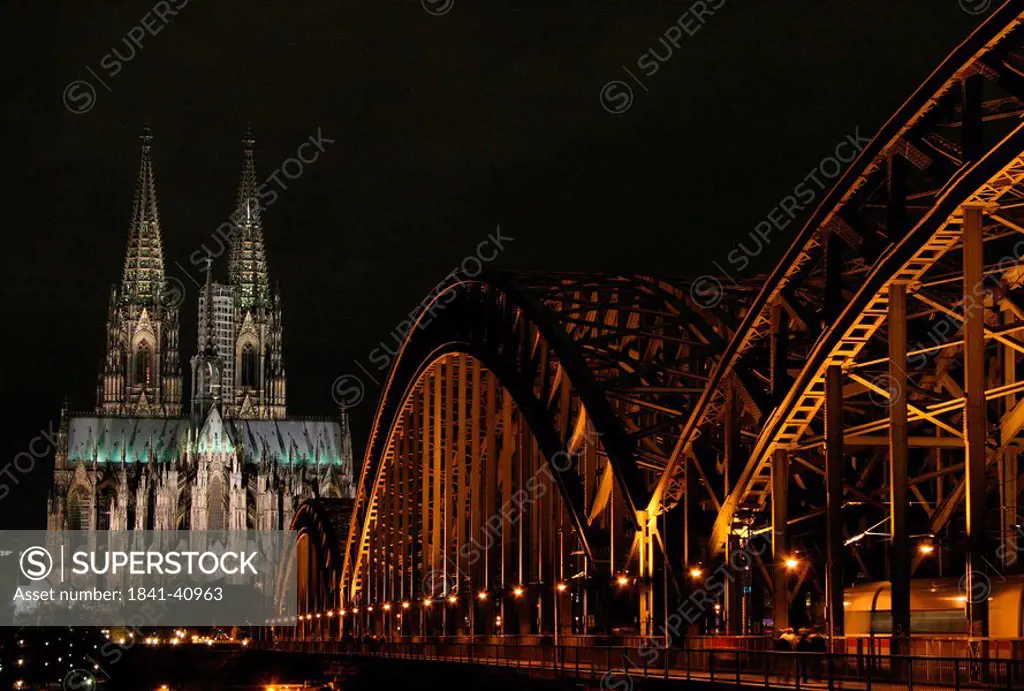 Cathedral and bridge lit up at night, Hohenzollern Bridge, Cologne Cathedral, Cologne, Rhineland, North Rhine_Westphalia, Germany