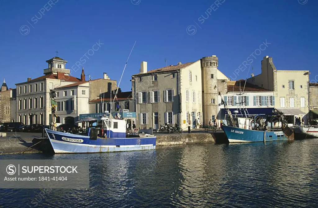Boats in the canal with houses in the background, France