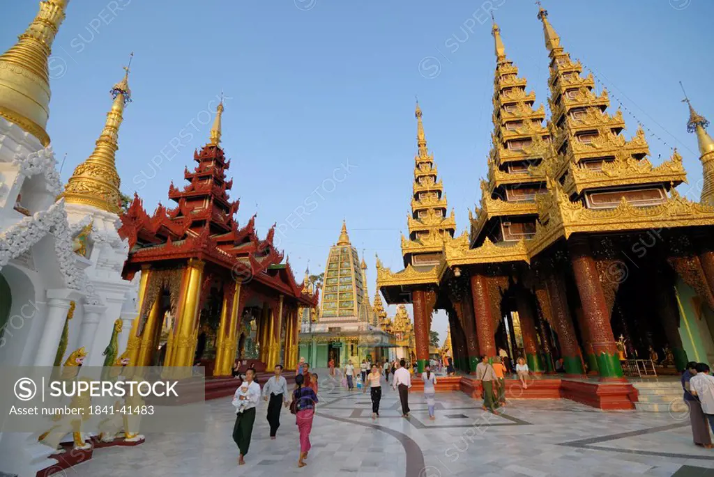 Group of people in Buddhist temple, Shwedagon Pagoda, Yangon, Myanmar