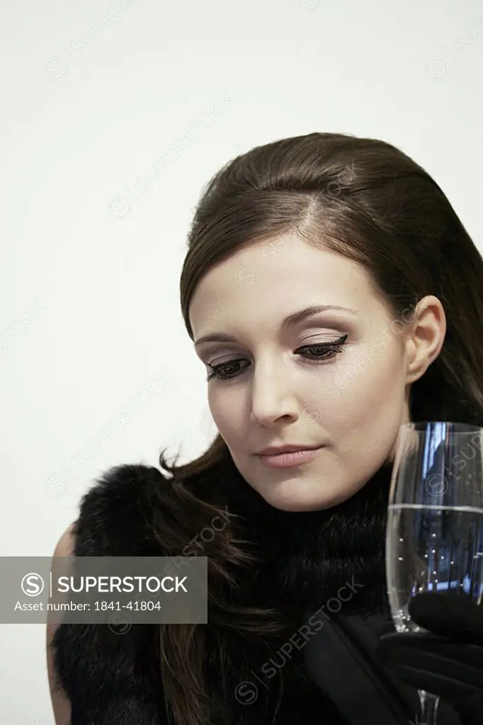 Close_up of young woman holding champagne flute