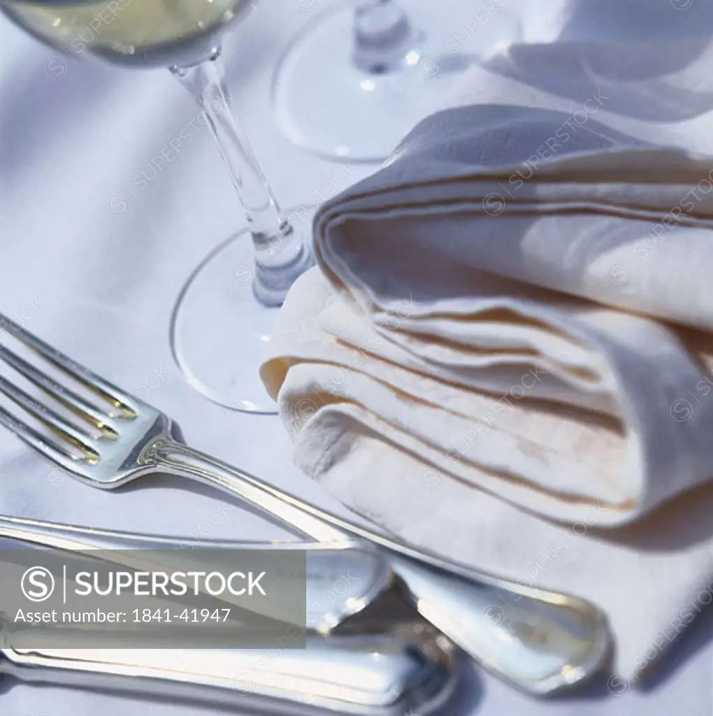 Close_up of napkin and fork on table