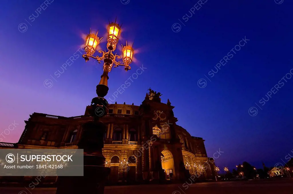 Lamppost in front of opera house lit up at night, Semper Opera House, Dresden, Saxony, Germany