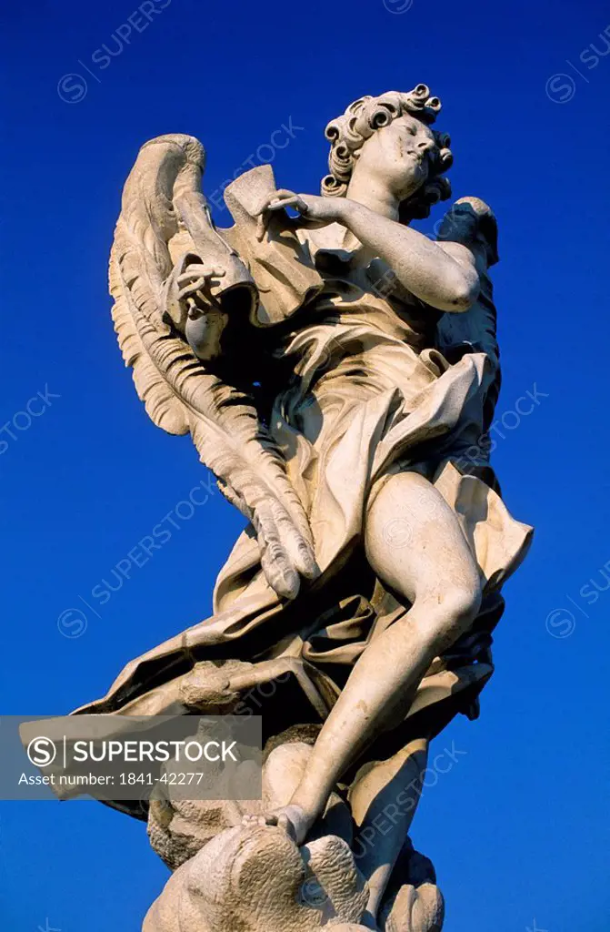 Low angle view of sculpture against blue sky, Rome, Italy