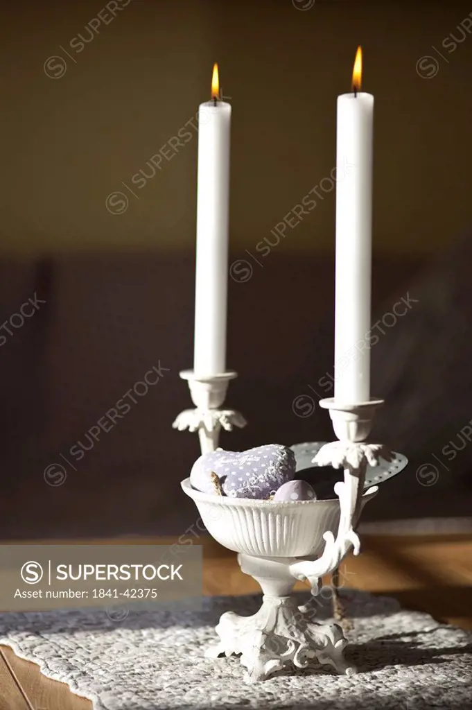 Candleholder with candles on a table, close_up