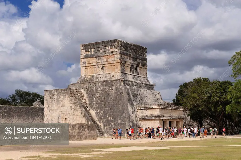 Group of tourists in front of the Temple of Jaguar at the Maya ruin site of Chichen Itza, Yucatan, Mexico