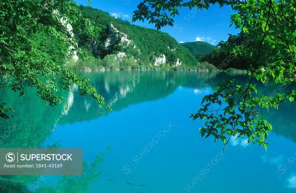 Hills and blue sky reflected in the lake water, Krka National Park, Dalmatia, Croatia